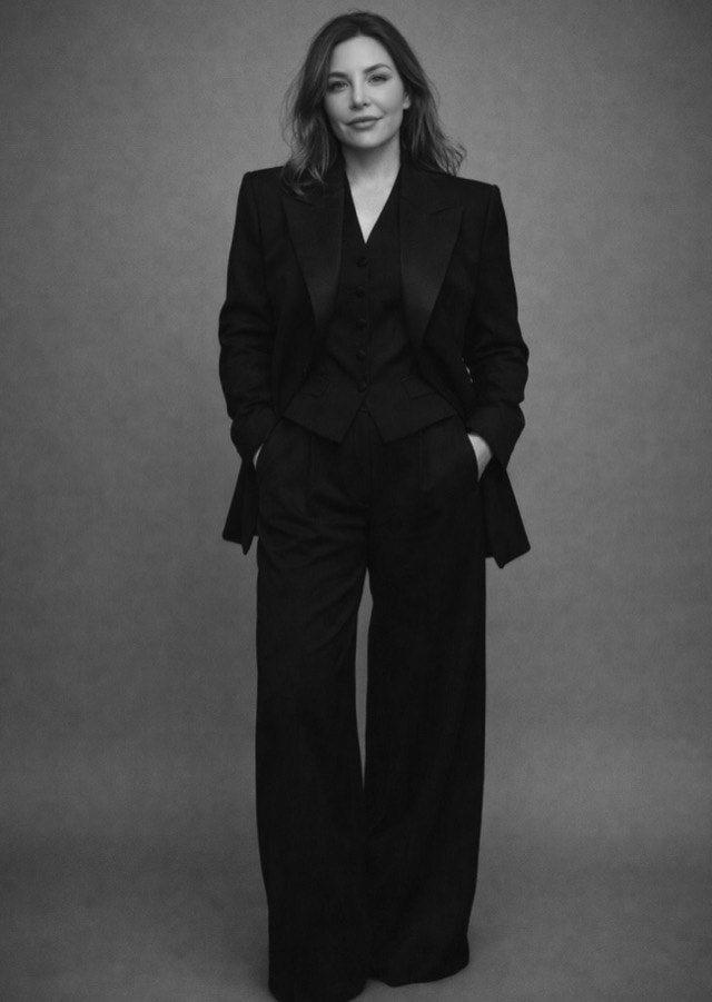 Steph Hamill, full-length portrait in a black suit